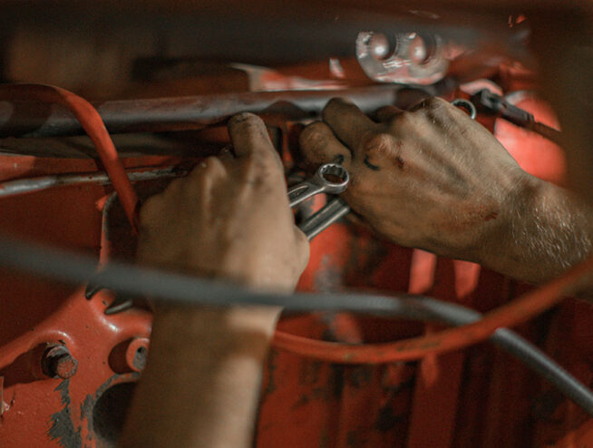 Hands are repairing machines.