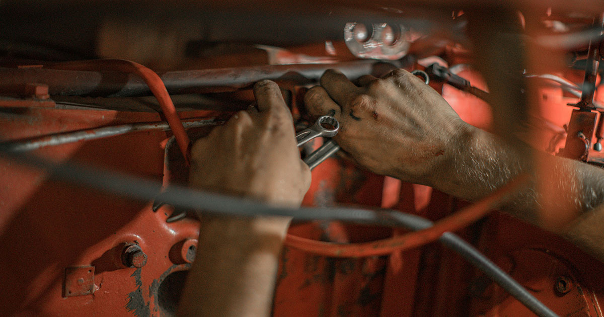 Hands are repairing machines.